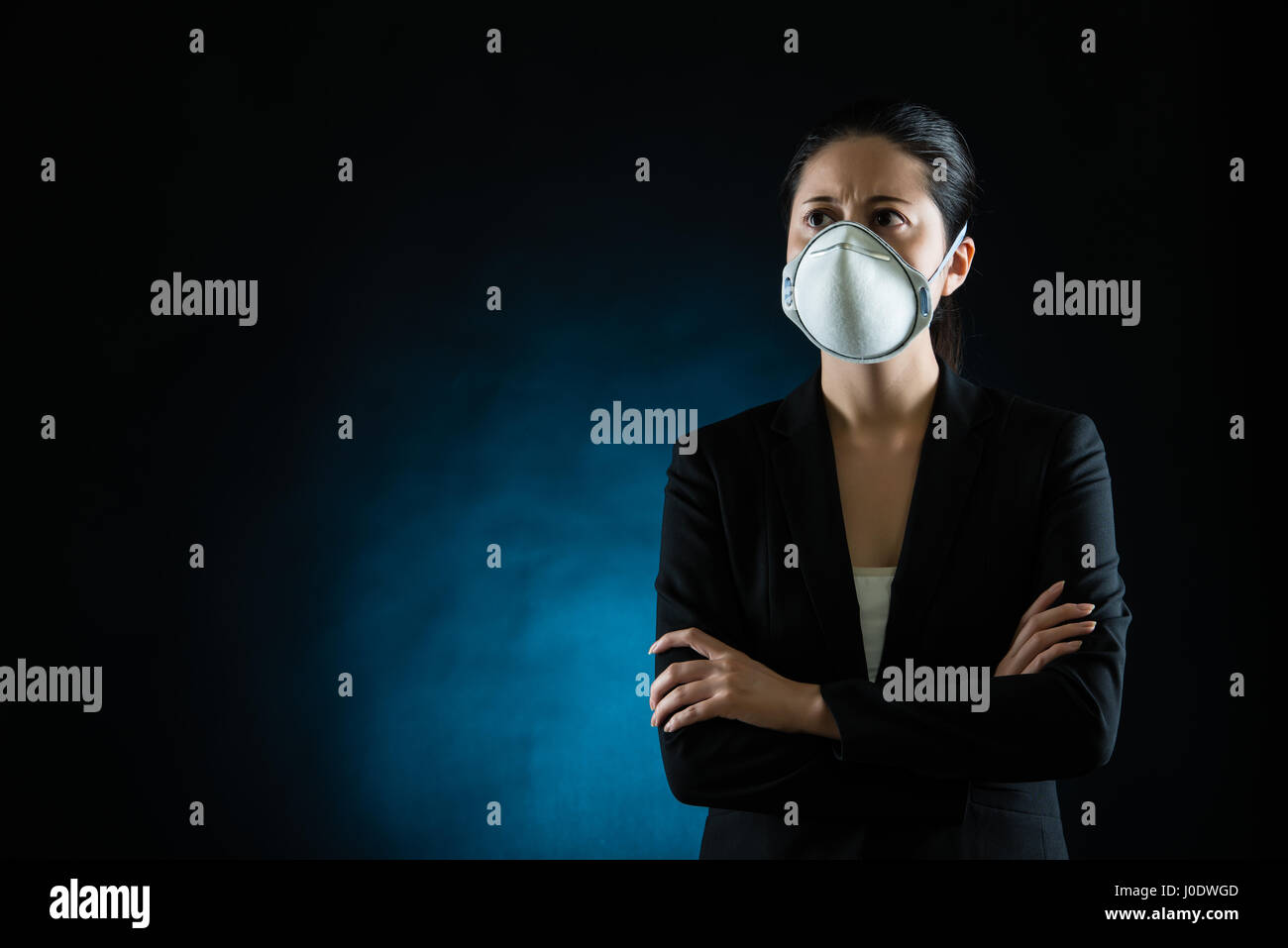Person wearing protective mask against transmissible infectious diseases and as protection against pollution and the flu. Beautiful mixed race asian c Stock Photo