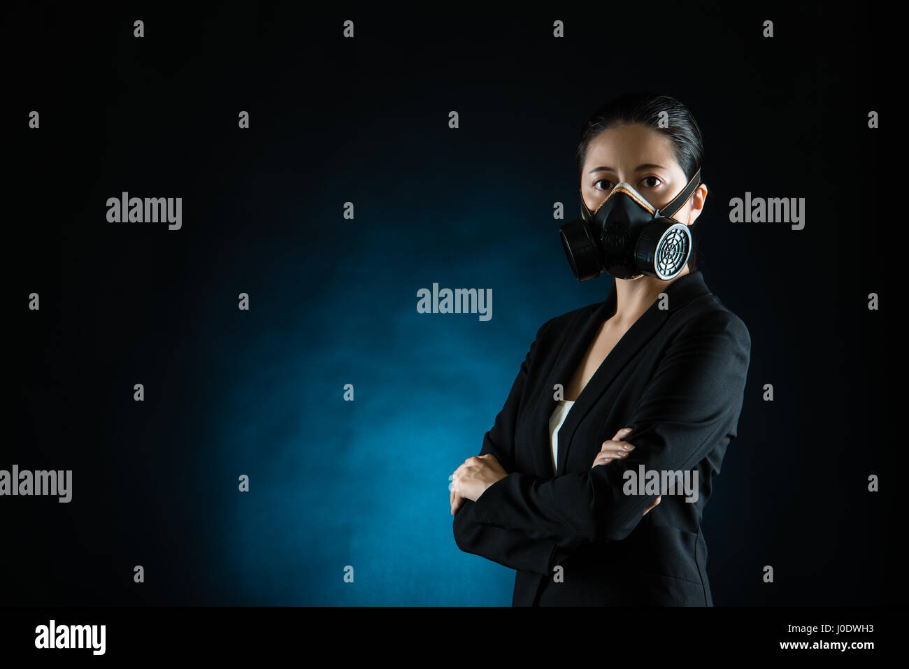 Asian business woman wear face mask in pollution city. concept of industry air pollution. mixed race asian chinese Stock Photo