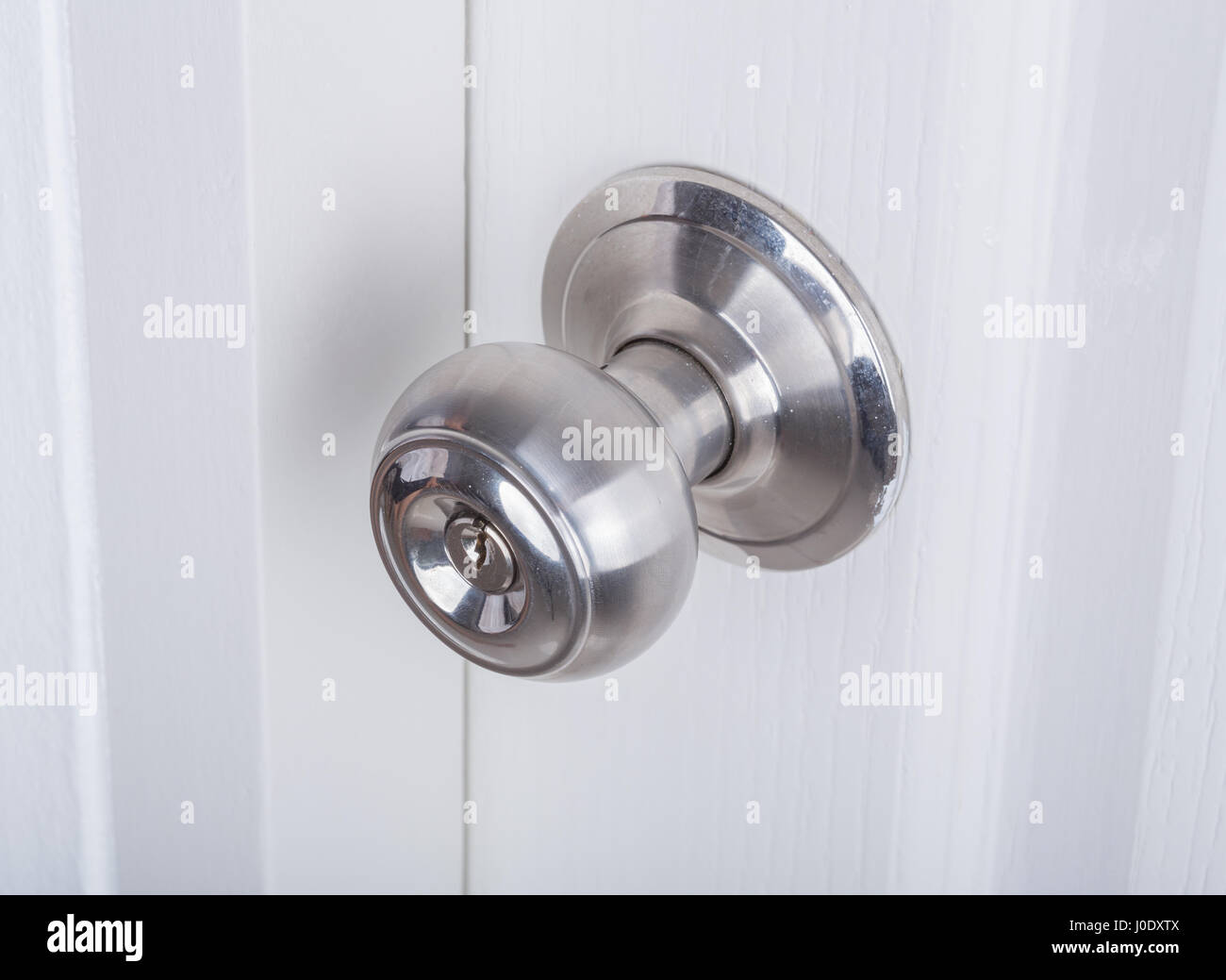 Aluminum door knob on the white door Stock Photo Alamy