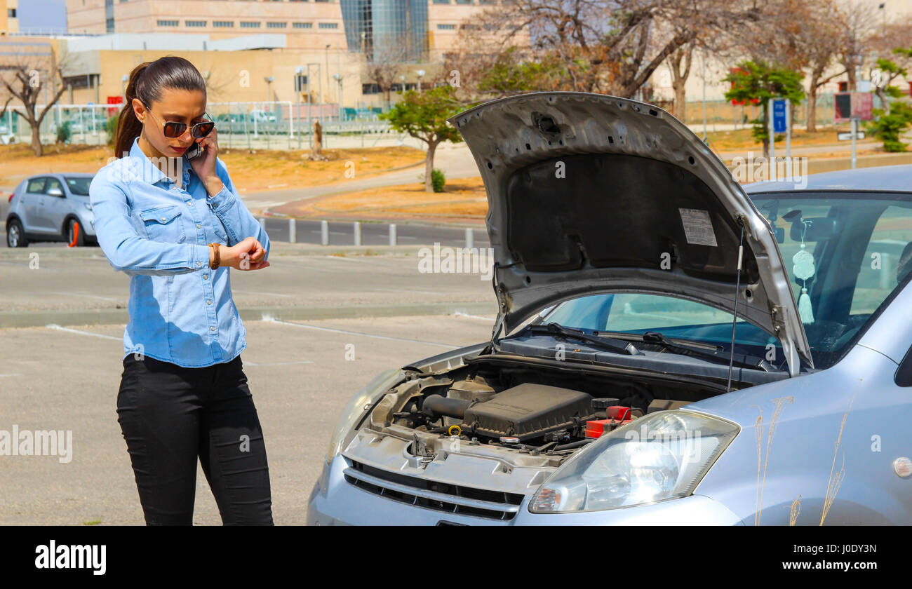 A woman gets stuck with a broken car, needs help, the car does not motivate Stock Photo Alamy