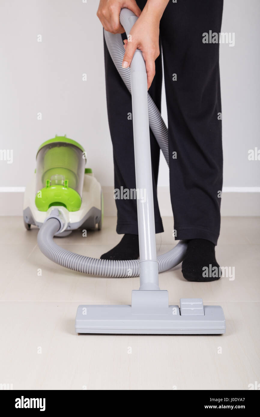 woman legs with vacuum cleaner cleaning floor at home Stock Photo - Alamy