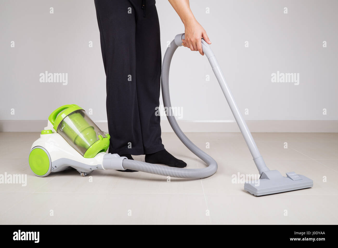 woman legs with vacuum cleaner cleaning floor at home Stock Photo - Alamy