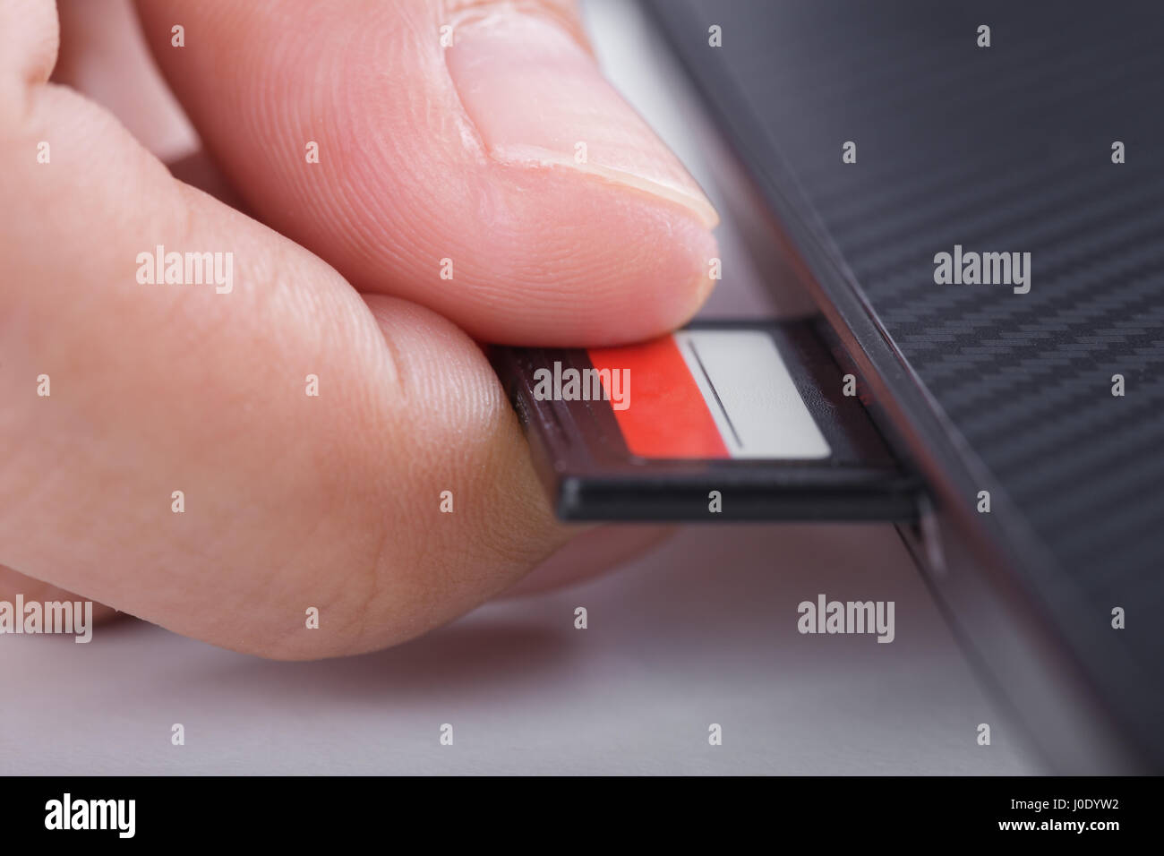 hand inserting SD card into laptop slot Stock Photo Alamy