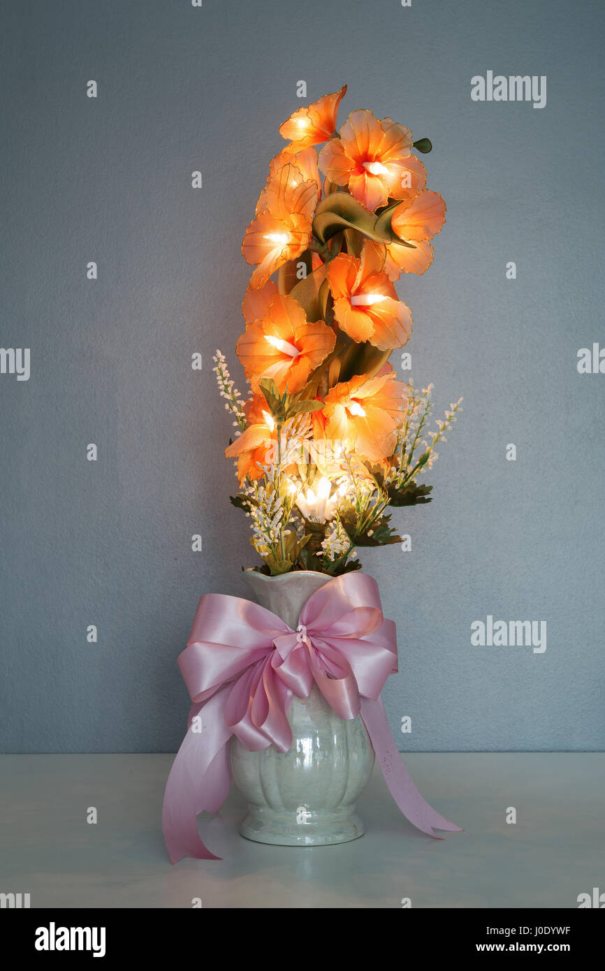electric flower in vase on table with wall background Stock Photo Alamy