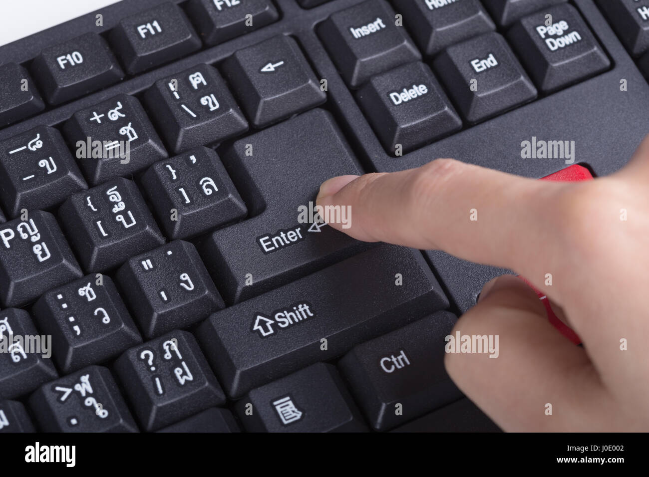 finger pushing enter button on a keyboard of computer Stock Photo Alamy