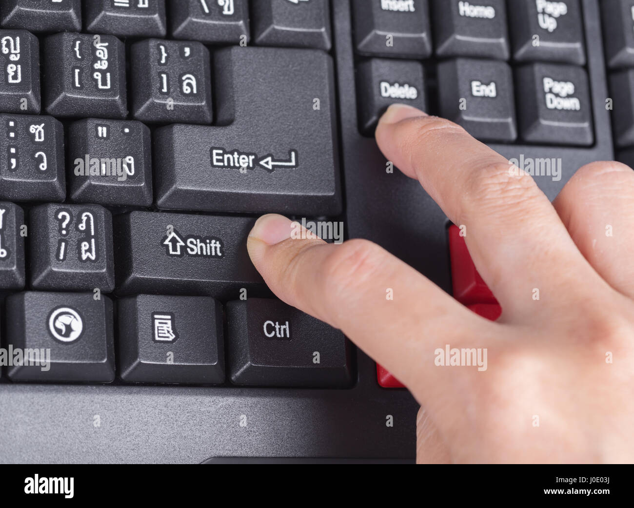 finger pushing shift delete button on a keyboard of computer Stock Photo