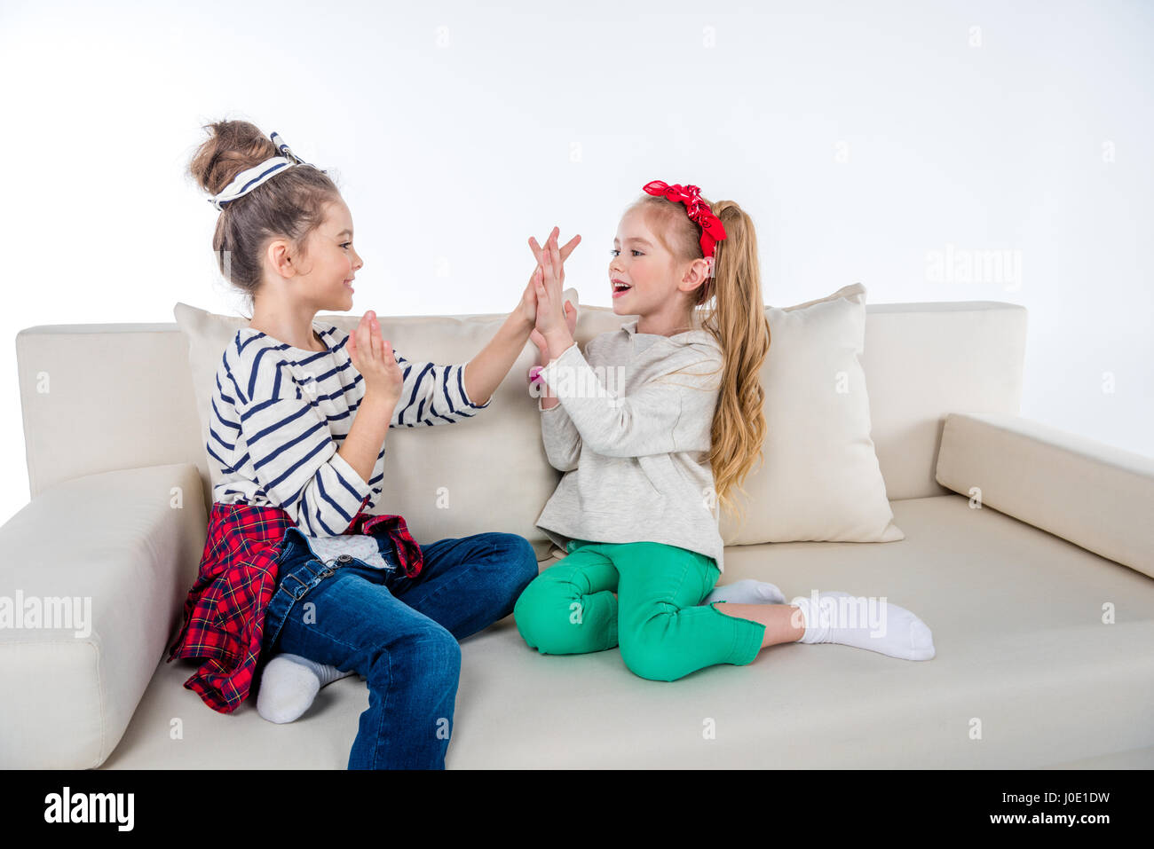 side view of cheerful girls playing pattycake game Stock Photo Alamy