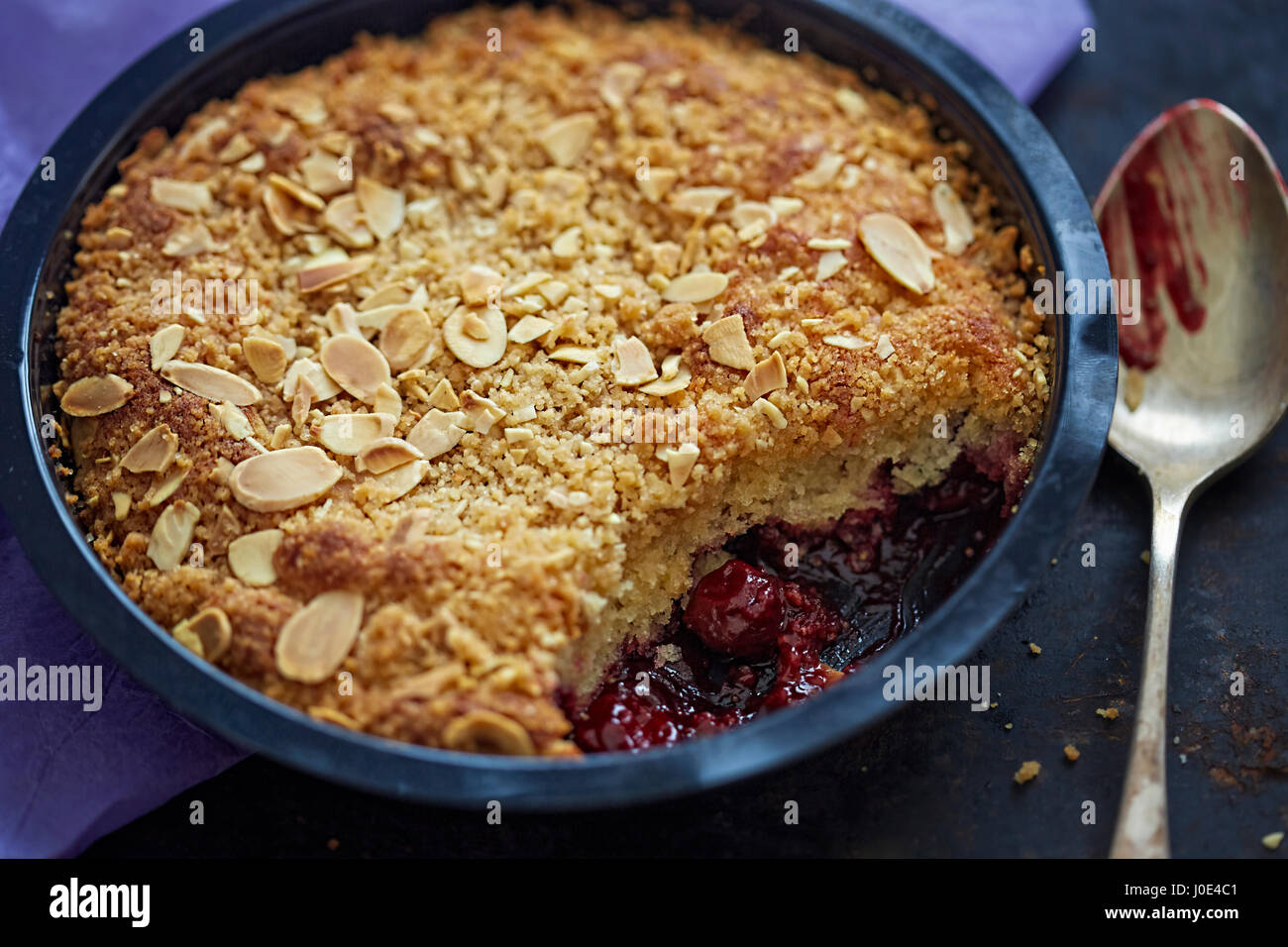 Almond pudding crumble cherry compote Stock Photo Alamy