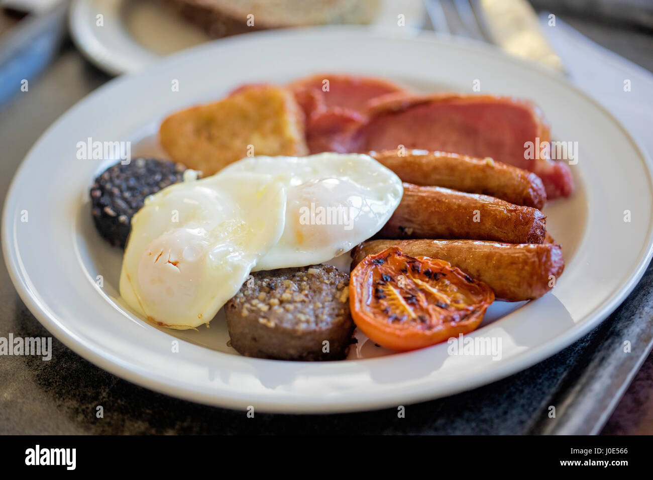 Full Irish breakfast pudding, egg, sausages, bacon, hash brown, tomato