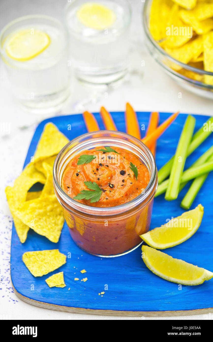 Vegetable dip with tortilla chips celery and carrot sticks Stock Photo