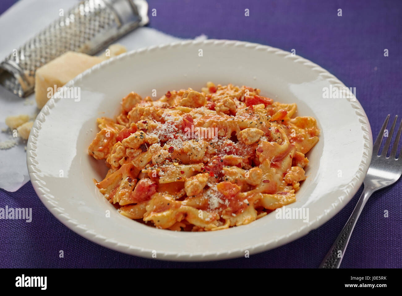 Pasta with tomato sauce and chicken pieces Stock Photo