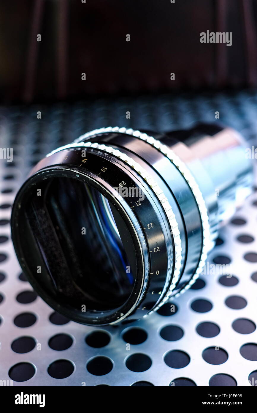 Vintage professional projection movie lens on metalic background Stock