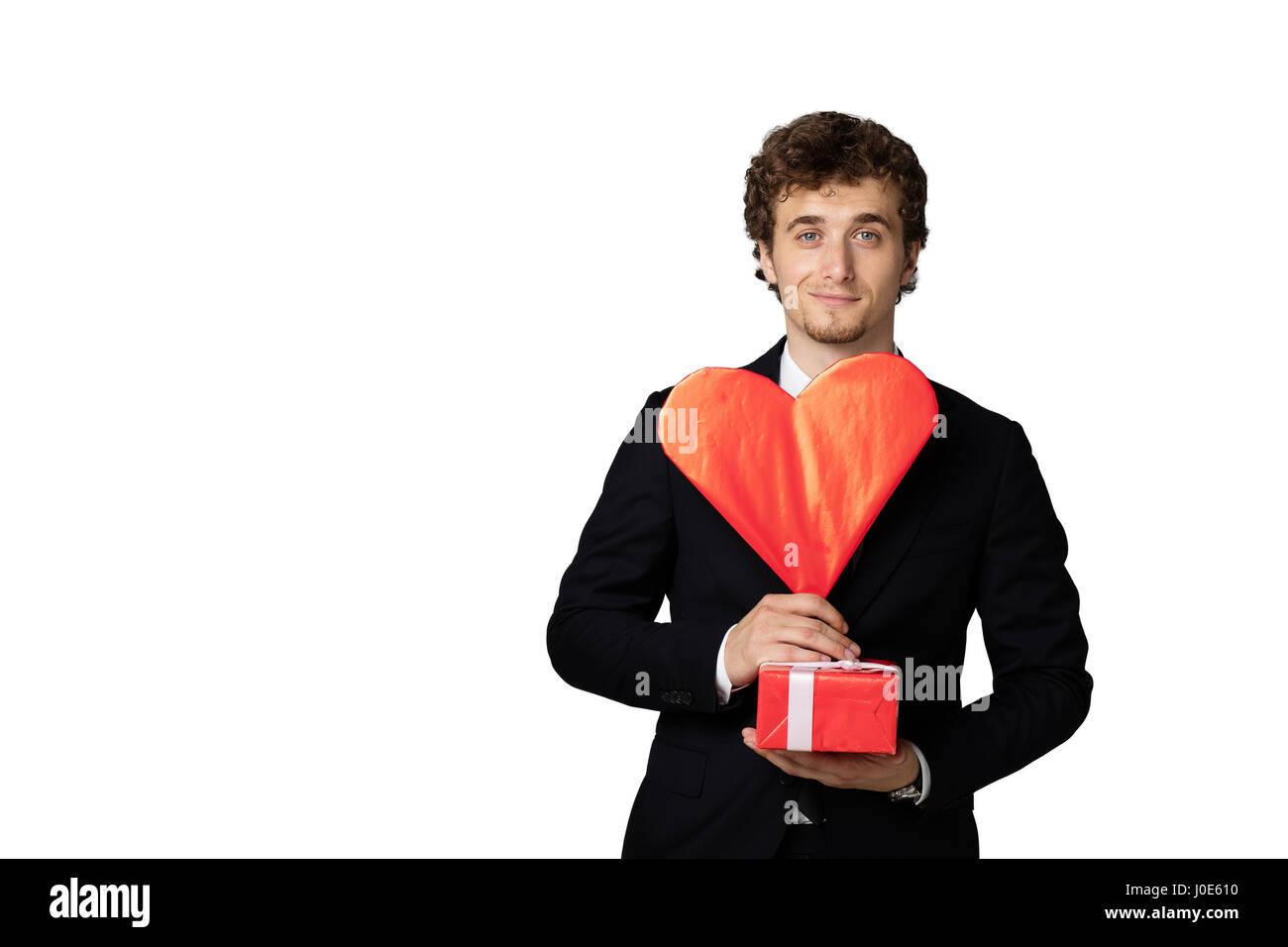 handsome elegant man in black elegant suit holding a heart and a red ...