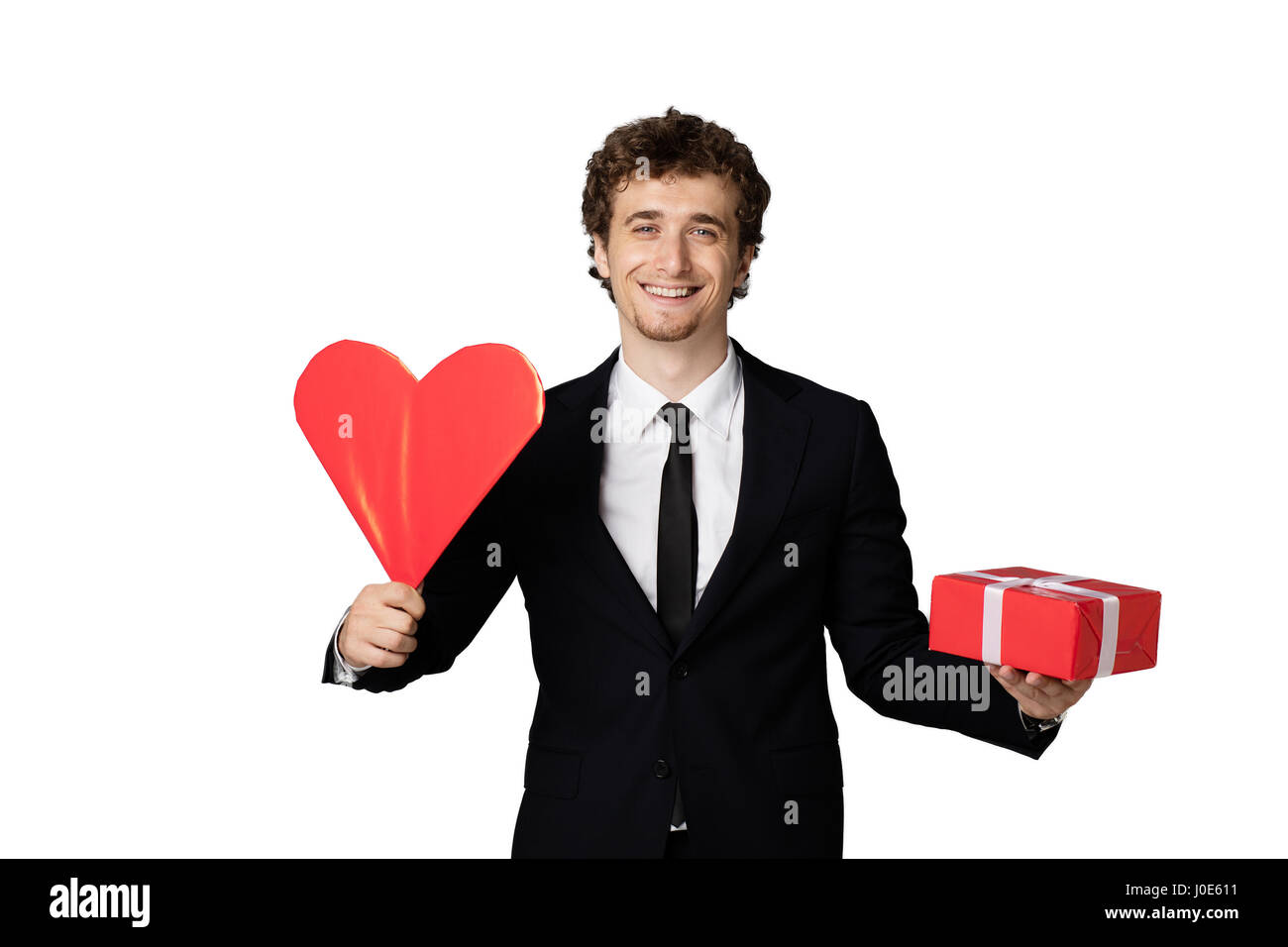 handsome elegant man in black elegant suit holding a heart and a red ...