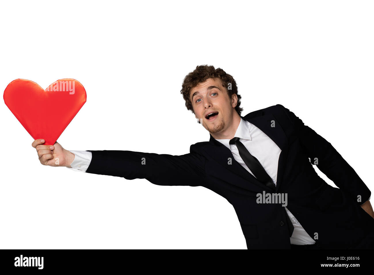 handsome young elegant men in black suit trying to hold his flying red ...