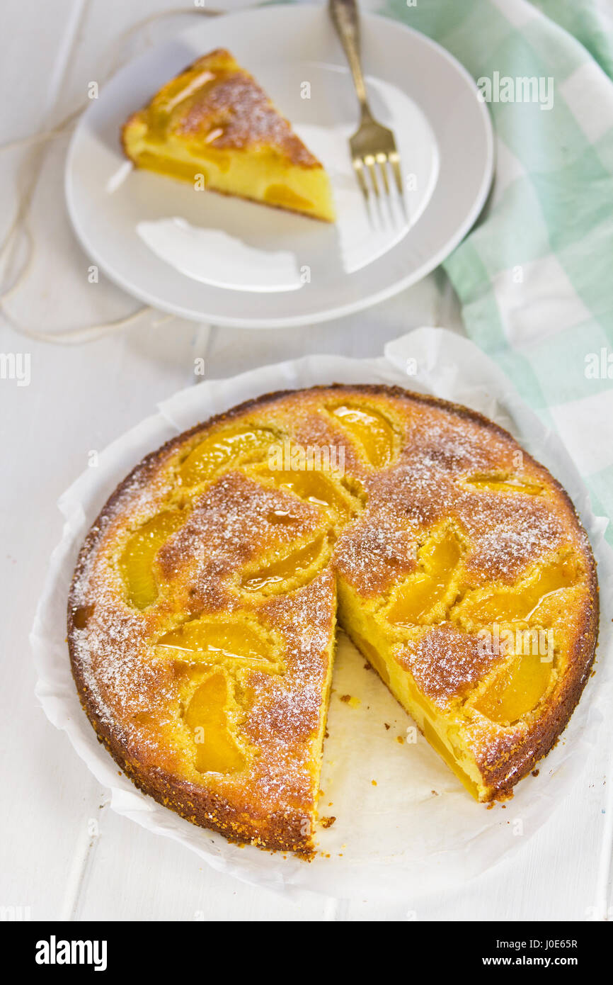 Lemon sponge cake with apricots and icing sugar Stock Photo Alamy