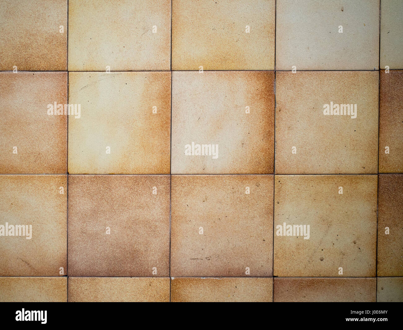 Vintage! Rather grimy old kitchen tiles without grout. Stock Photo