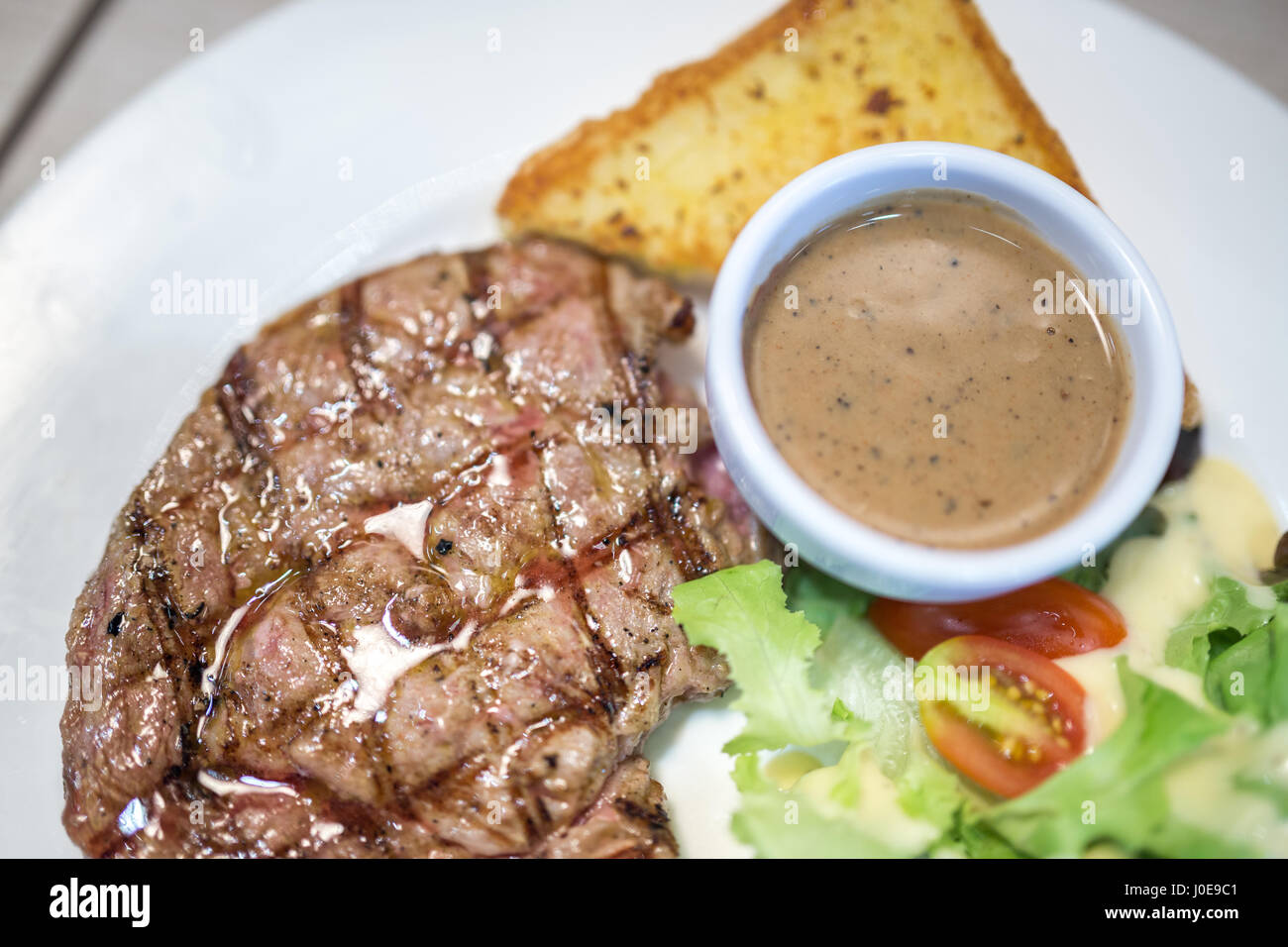 grilled steaks with black pepper sauce Stock Photo Alamy
