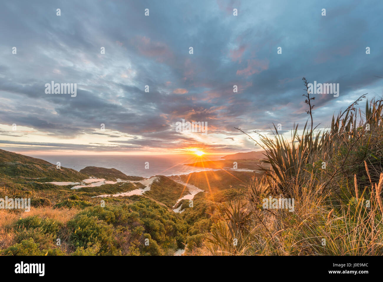 Sunset over the sea, sand dunes, Sandfly Bay, Dunedin, Otago, Otago Peninsula, Southland, New Zealand Stock Photo