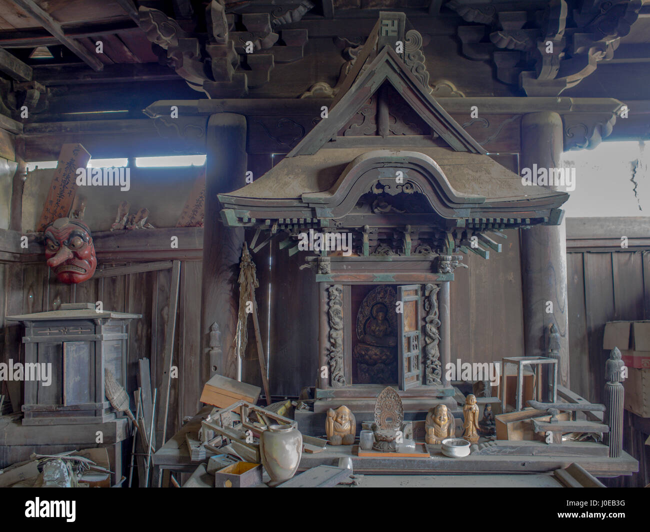 Altar and buddha statue, in an abandoned temple, a dusty clutter and