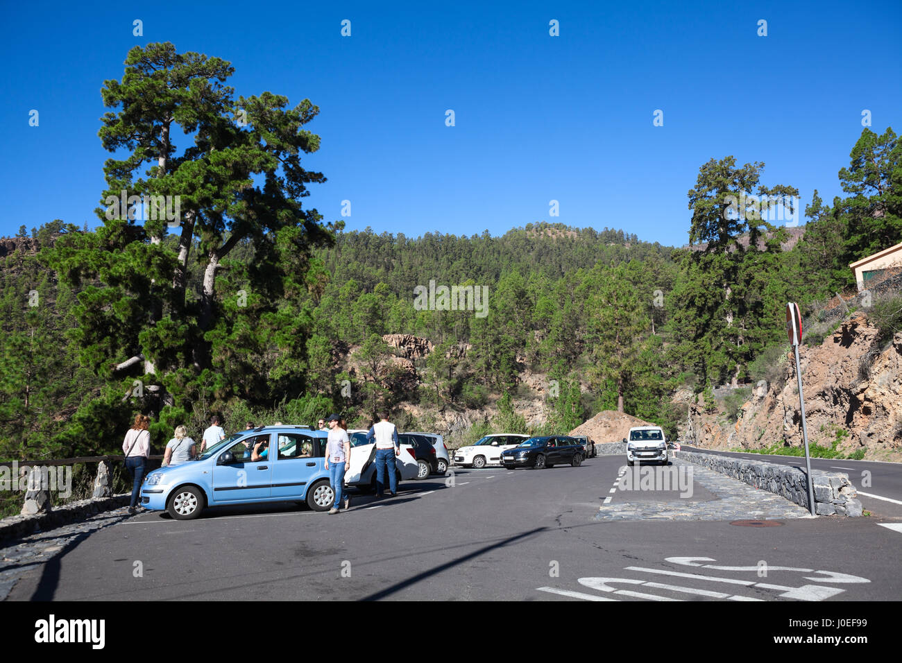 TENERIFE, SPAIN-CIRCA 2016, JAN: Parking area is on the TF-21 road for seeing a thousand-year pine in Vilaflor village. Tourists leave their small car Stock Photo