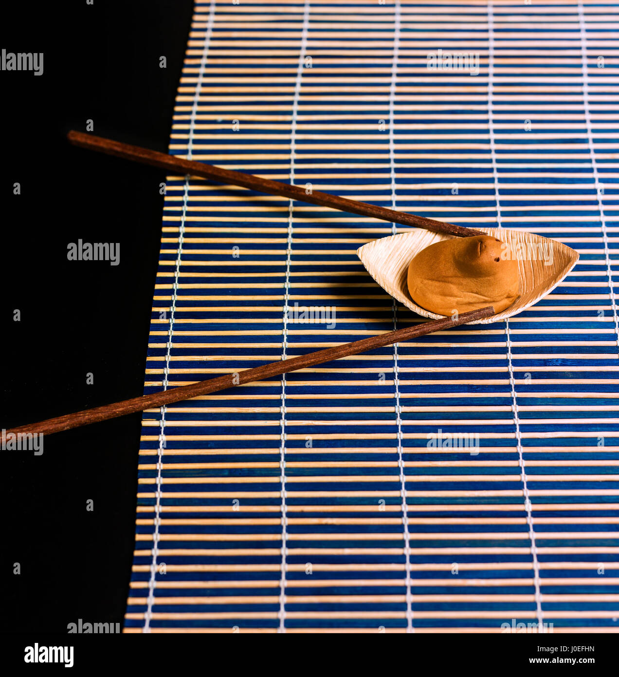 Japanese sweet shaped and an funny sweet animal rowing in a bamboo river Stock Photo
