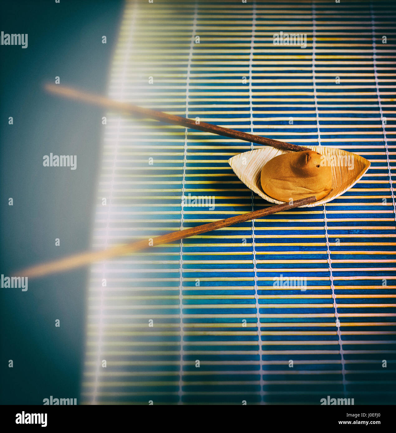 Japanese sweet shaped and an funny sweet animal rowing in a bamboo river Stock Photo