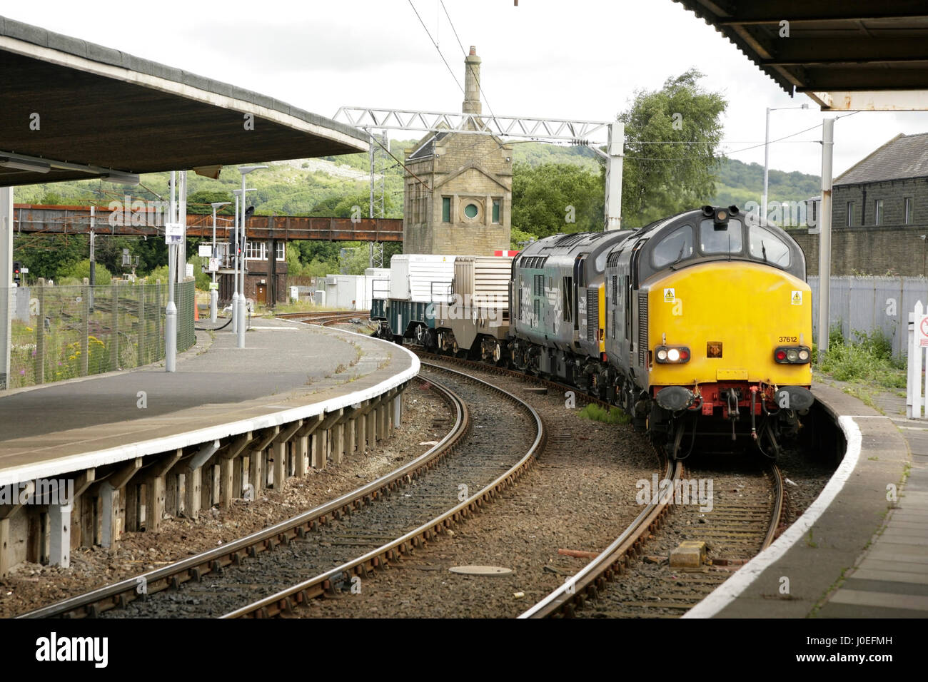 Direct Rail Services Class 37 diesel locomotives hauling nuclear flasks from Sellafield reprocessing plant through Carnforth railway station, UK. Stock Photo