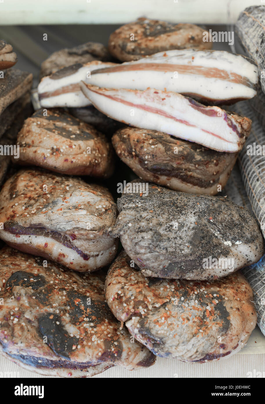 Bacon and cheek lard whole and sliced heap on market shelf Stock Photo