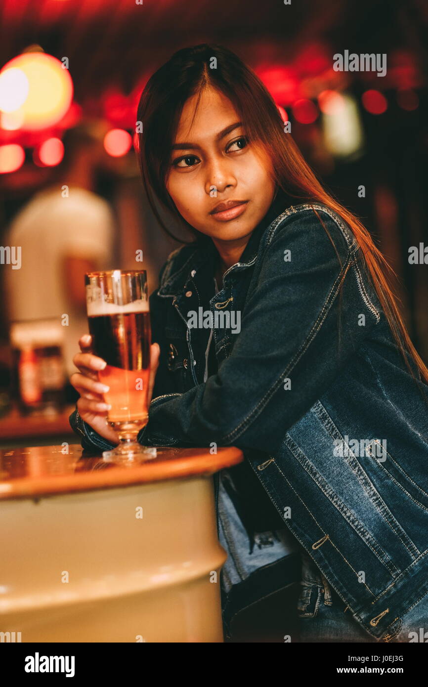 Young Beautiful Woman Drinking Beer In A Bar Stock Photo - Alamy