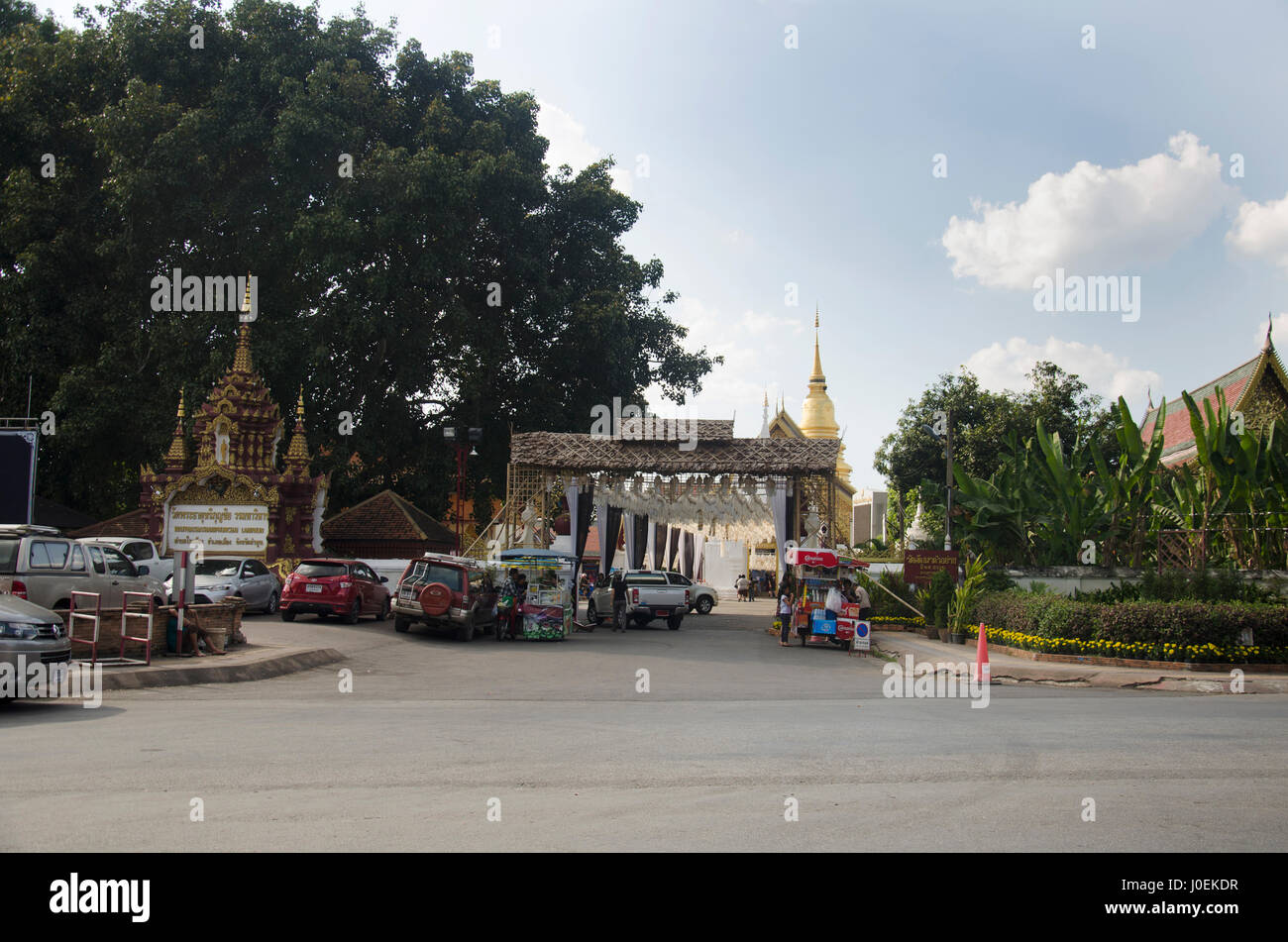 Landscape and car parking at front Wat Phra That Hariphunchai temple for people respect praying and visit chedi on December 28, 2016 in Lamphun, Thail Stock Photo
