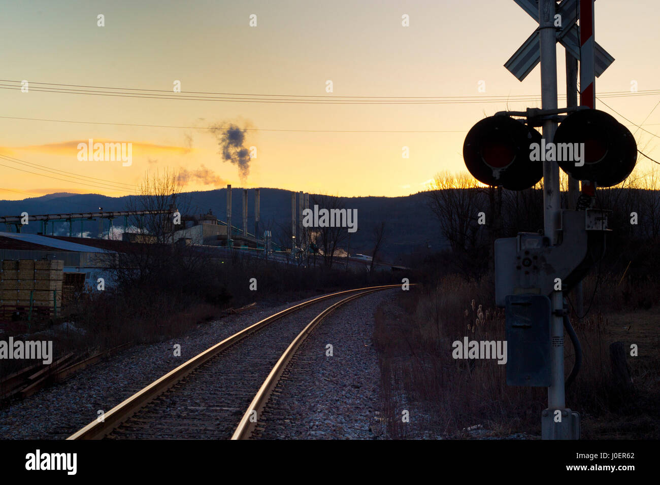 Train tracks run through an industrial park near the border between New York and Vermont. Stock Photo