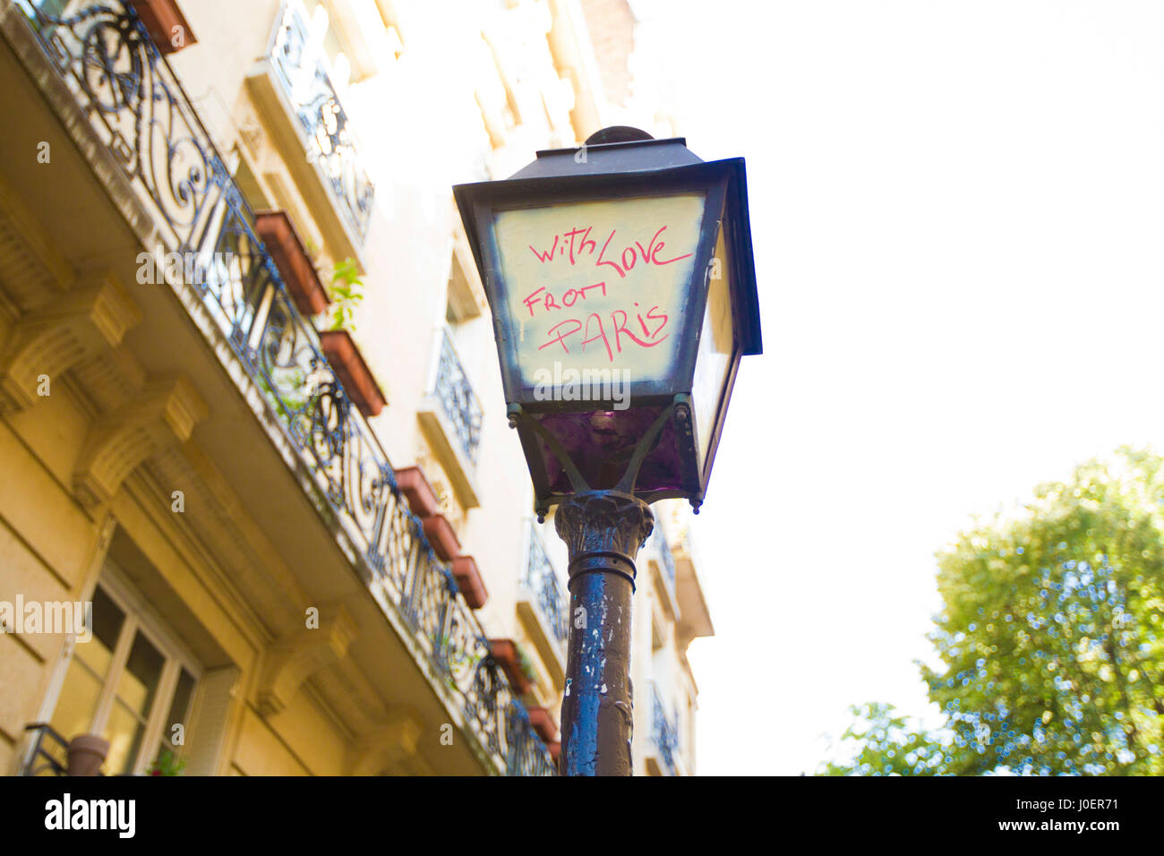With Love From Paris' Graffiti on a Paris street lamp.' Stock Photo