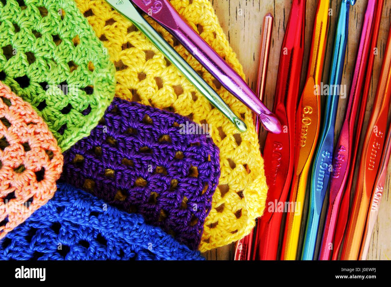 Photo of colorful crochet hooks and granny squares Stock Photo Alamy
