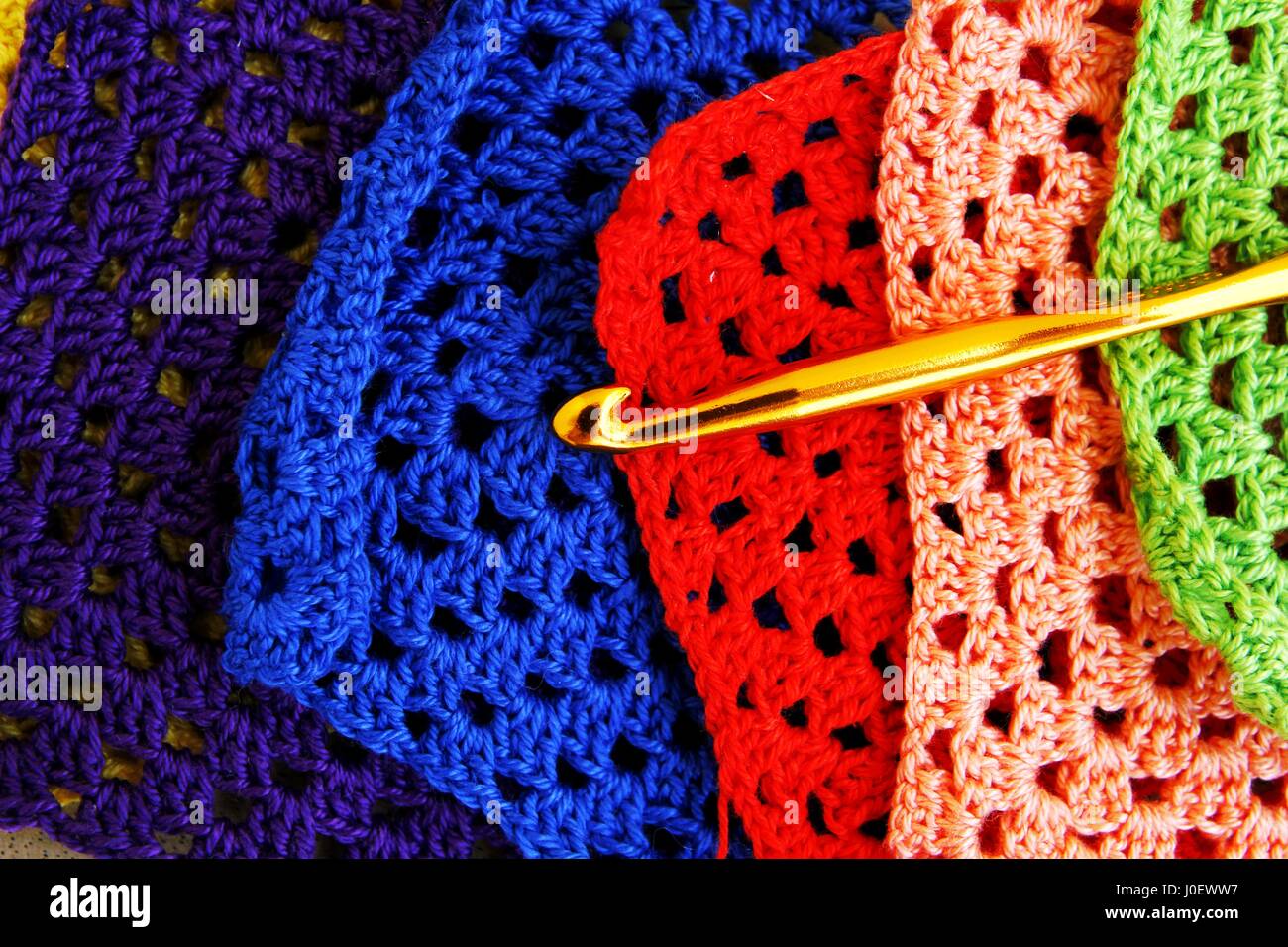 Photo of colorful crochet hooks and granny squares Stock Photo Alamy