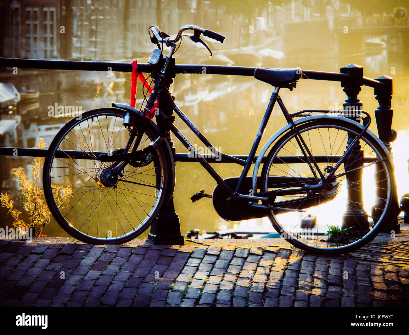 Amsterdam, Netherlands, province of North Holland,  bicycle parked at the bridge. Stock Photo