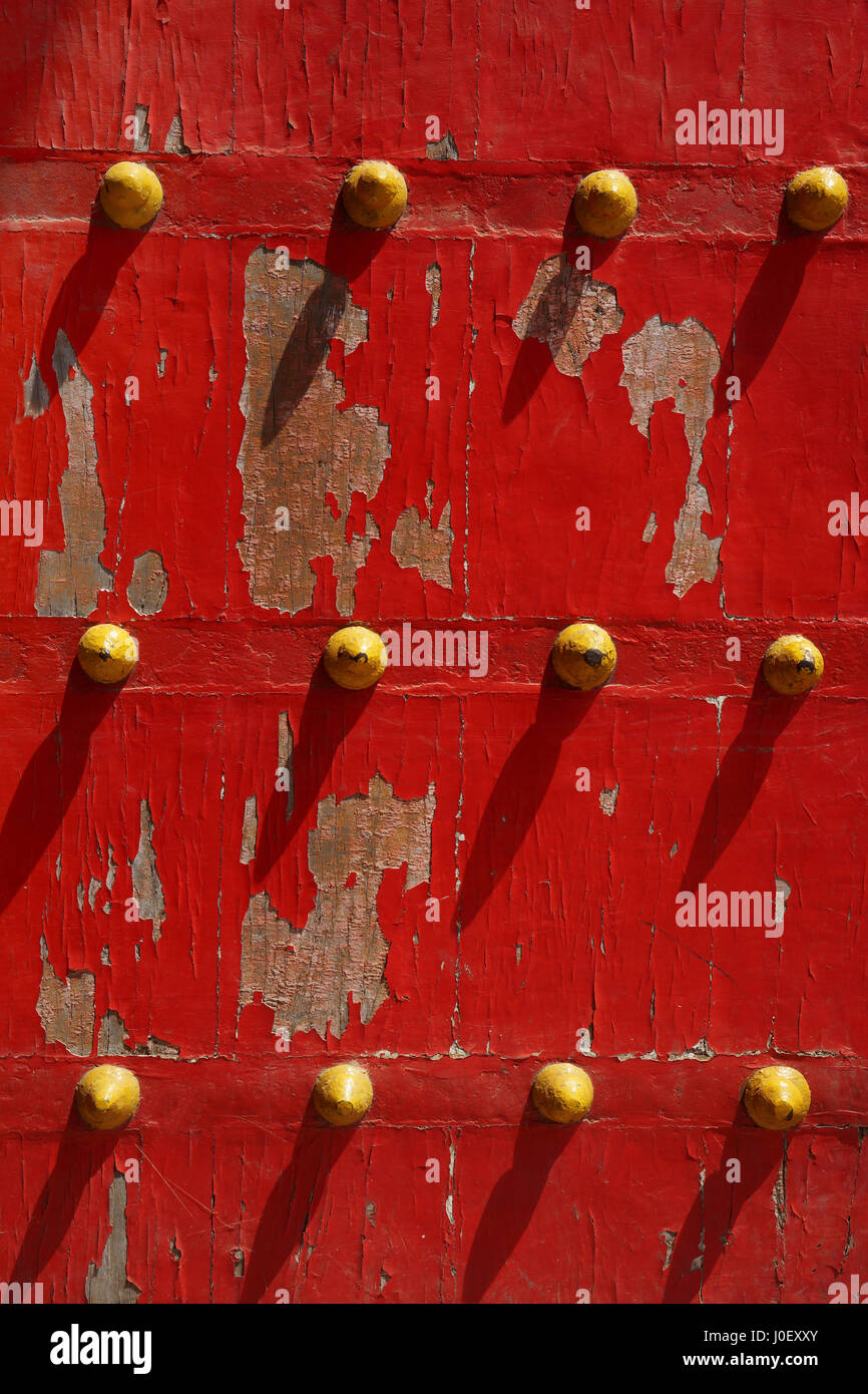 Twelve yellow dots on red old wooden door, varanasi, uttar pradesh, india, asia Stock Photo