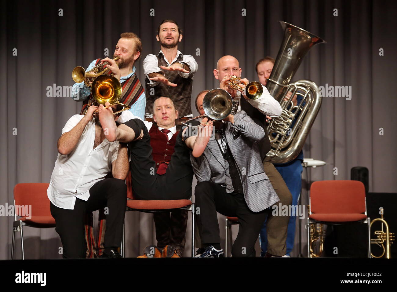 Mnozil Brass, Austrian brass septet, concert and music comedy program 'Yes, Yes, Yes', Kongresshalle Giessen/Germany, 20th January 2017 - in picture: Leonhard Paul (mid, on chair) plays with fingers and feeds the valves of the other musicians's trumpets and trombones. Fotocredit: Christian Lademann Stock Photo