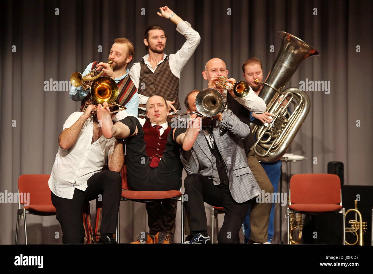 Mnozil Brass, Austrian brass septet, concert and music comedy program 'Yes, Yes, Yes', Kongresshalle Giessen/Germany, 20th January 2017 - in picture: Leonhard Paul (mid, on chair) plays with fingers and feeds the valves of the other musicians's trumpets and trombones. Fotocredit: Christian Lademann Stock Photo