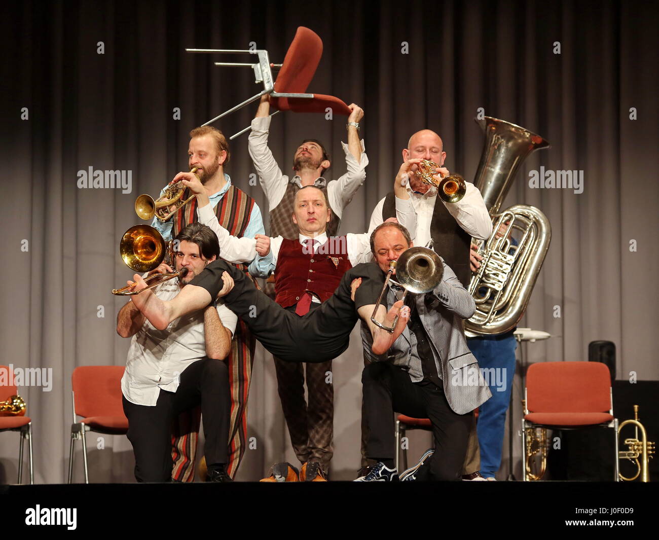 Mnozil Brass, Austrian brass septet, concert and music comedy program 'Yes, Yes, Yes', Kongresshalle Giessen/Germany, 20th January 2017 - in picture: Leonhard Paul (mid, on chair) plays with fingers and feeds the valves of the other musicians's trumpets and trombones. Fotocredit: Christian Lademann Stock Photo