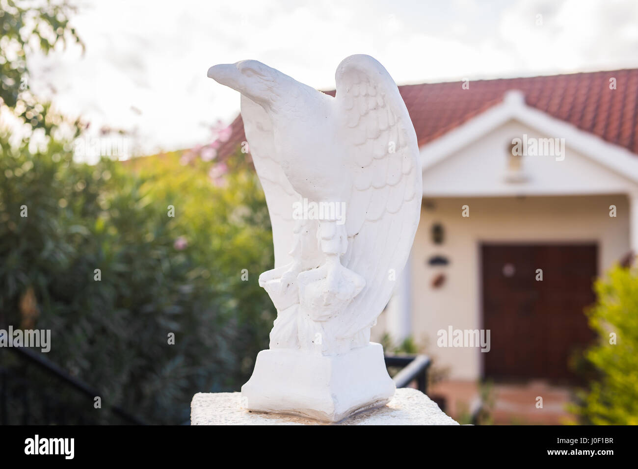 White eagle statue near the house Stock Photo Alamy