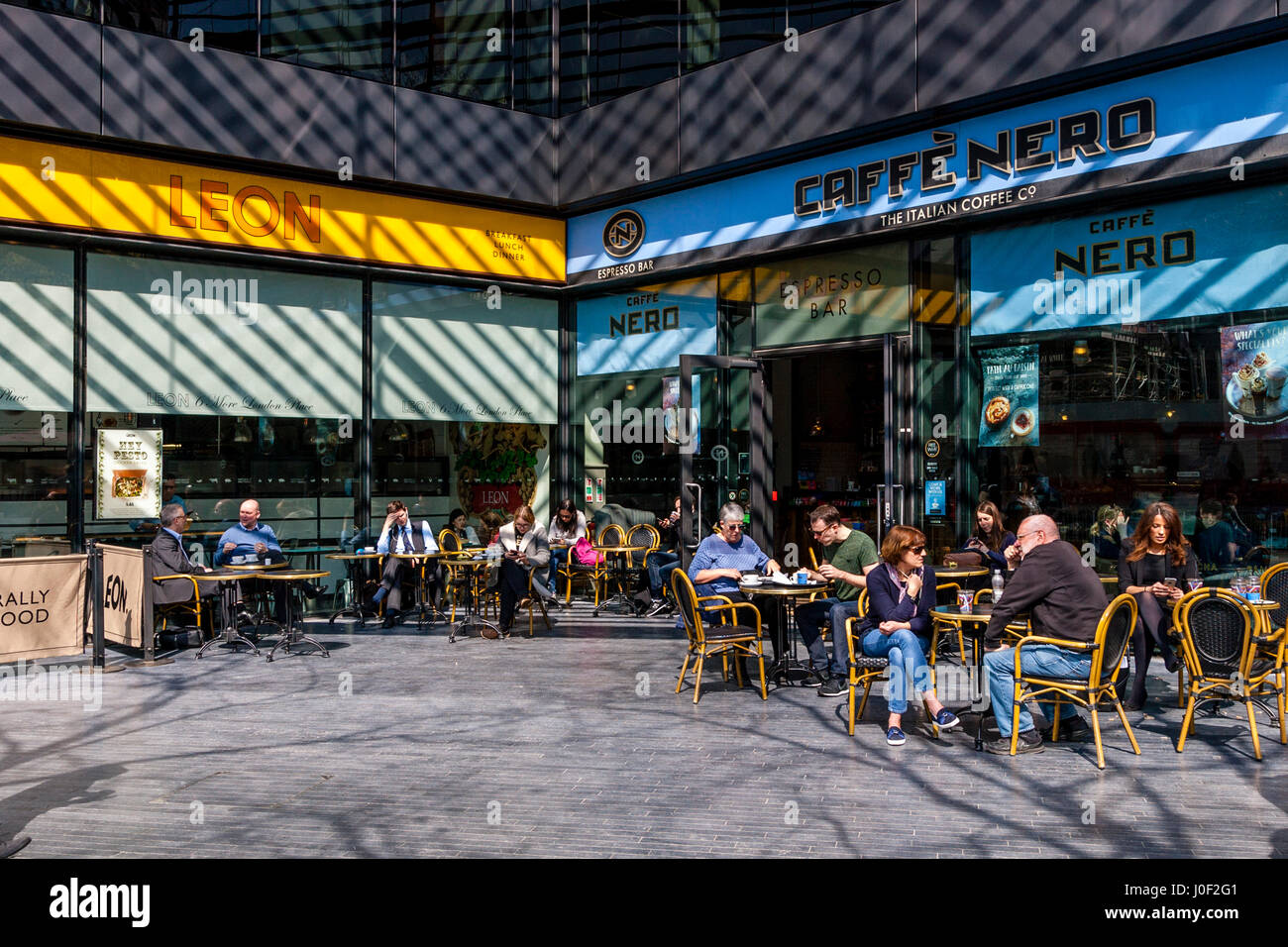 People Sitting Outside Cafes At The More London Development, London, England Stock Photo