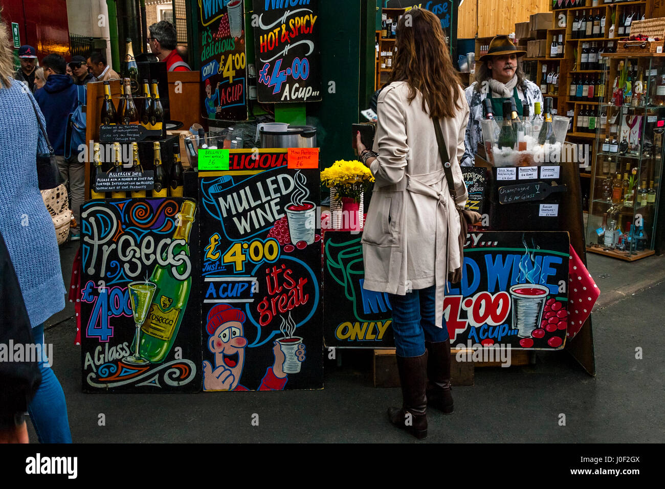 A Woman Buying Drinks From A Colourful Stall In Borough Market, London