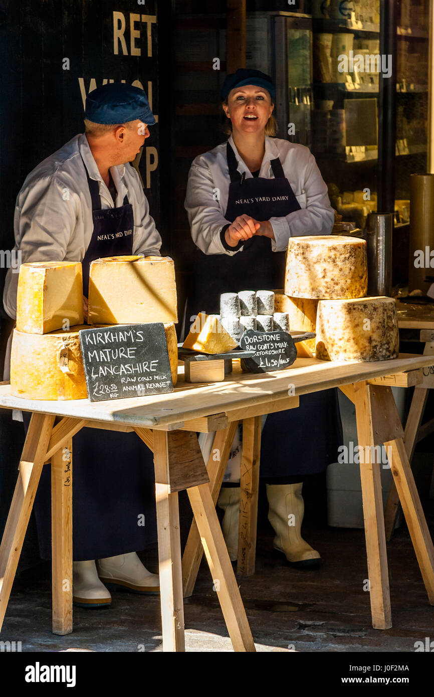 Two People Selling Cheese Outside Neal's Yard Dairy Shop, Park Street, Borough Market, London, England Stock Photo