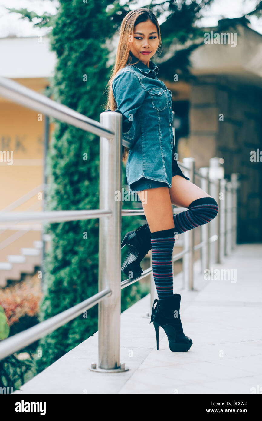 Fashionable pretty young woman wearing striped knee socks Stock Photo
