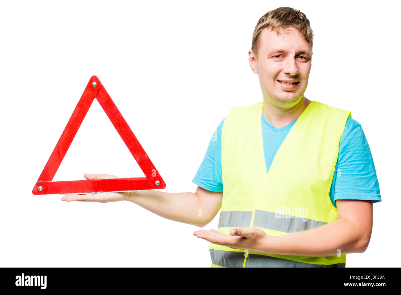 Happy mechanic demonstrates emergency stop sign on white background Stock Photo