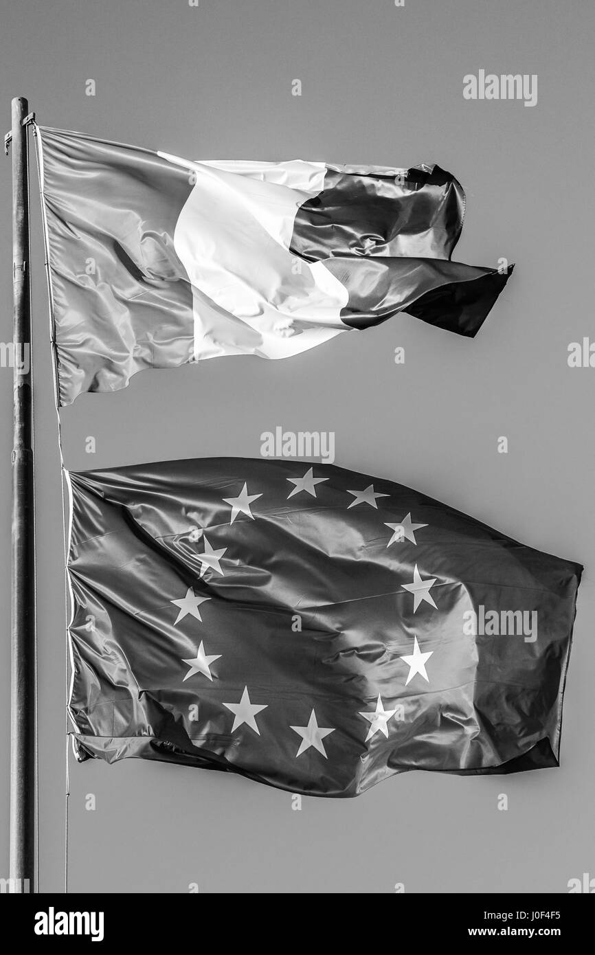 general three colors flag and Europe flag waving together in isolated the grey sky background. black and white. Concept for old financial treated, uni Stock Photo