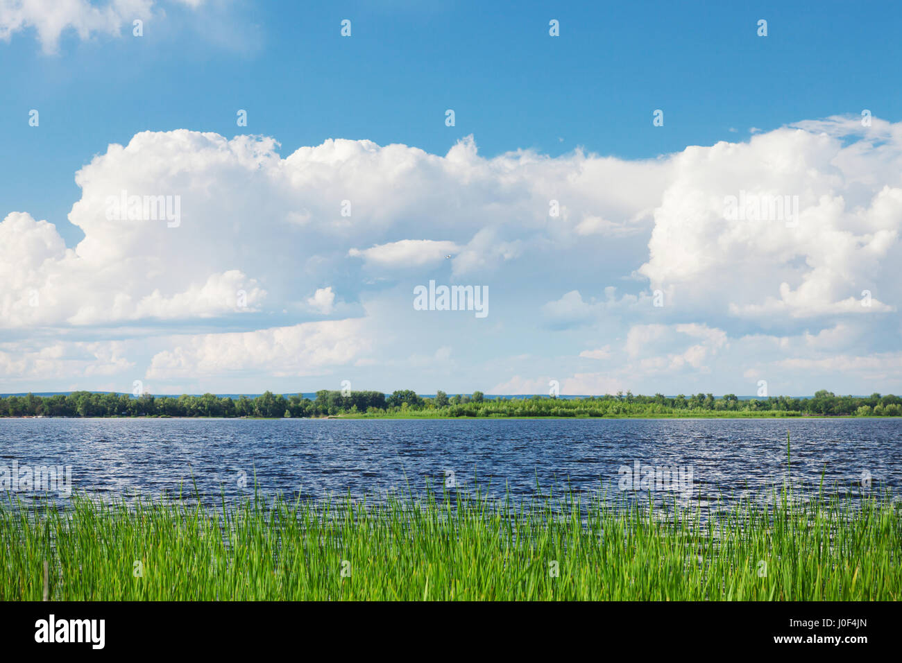 Landscape with river and cloudy sky. Sunny summer scene Stock Photo - Alamy