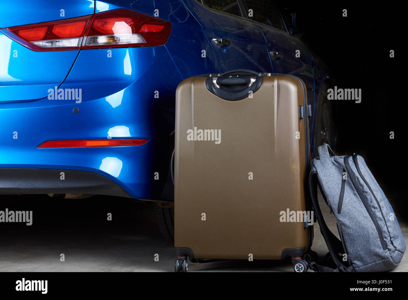 Road auto trip on blue modern car. Luggage bags stand next to modern car Stock Photo