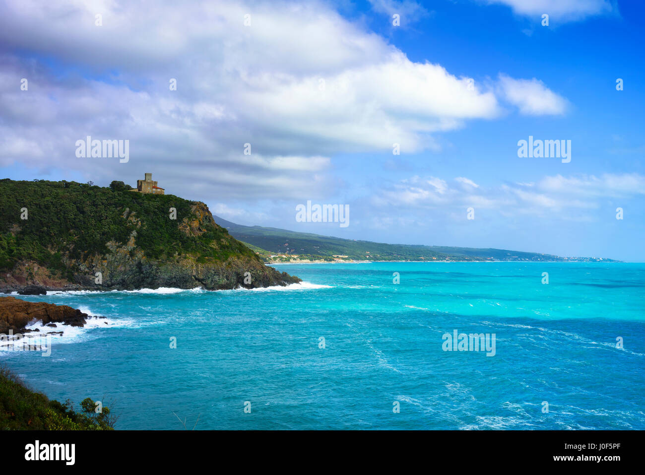 Cliff rock and building on the sea on sunset. Quercianella coast, Tuscany riviera, Italy, Europe. Stock Photo